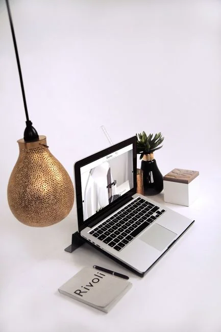 Person shopping online using a laptop and credit card, highlighting e-commerce convenience.